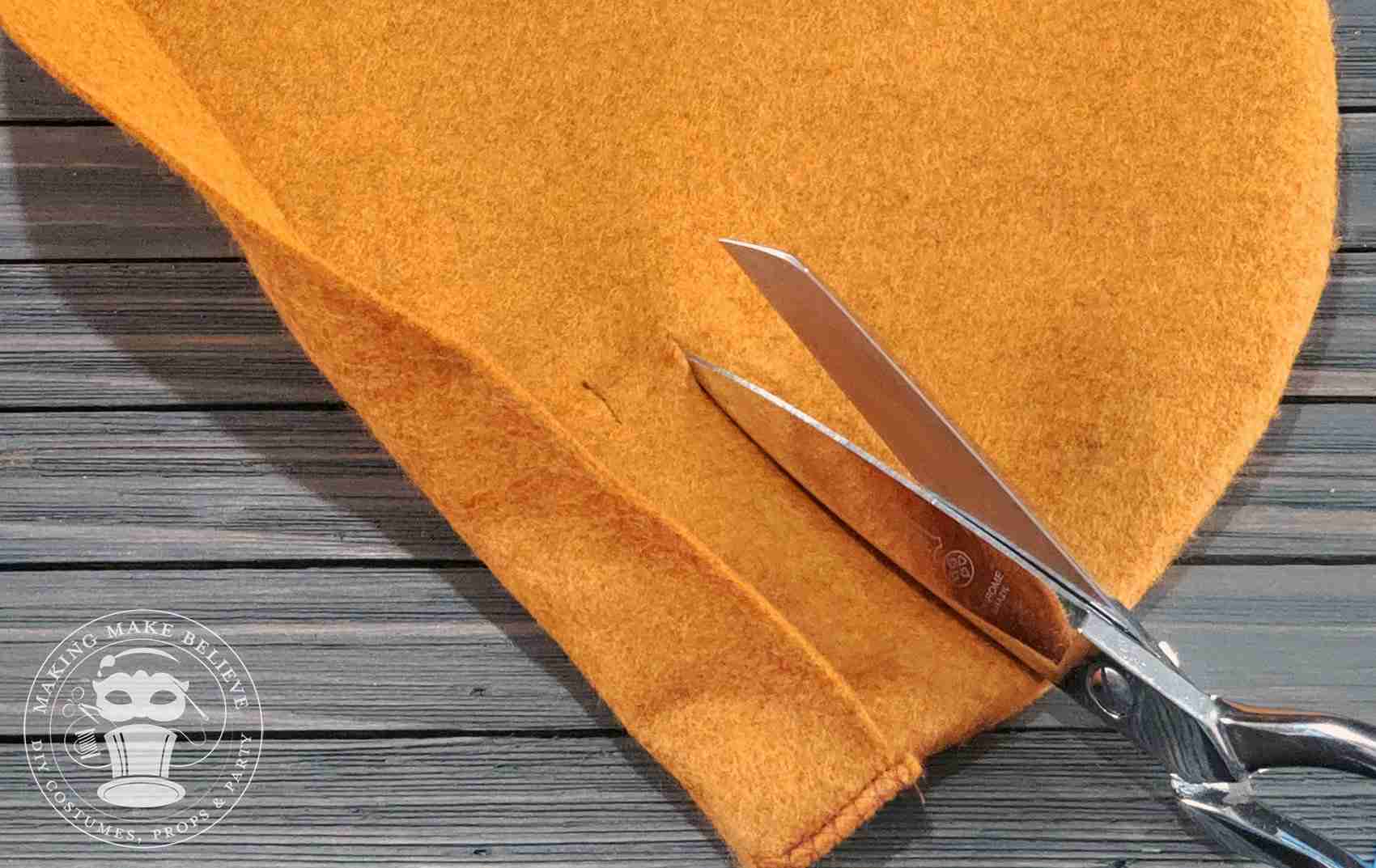 Cut slits for feather on Robin Hood Hat