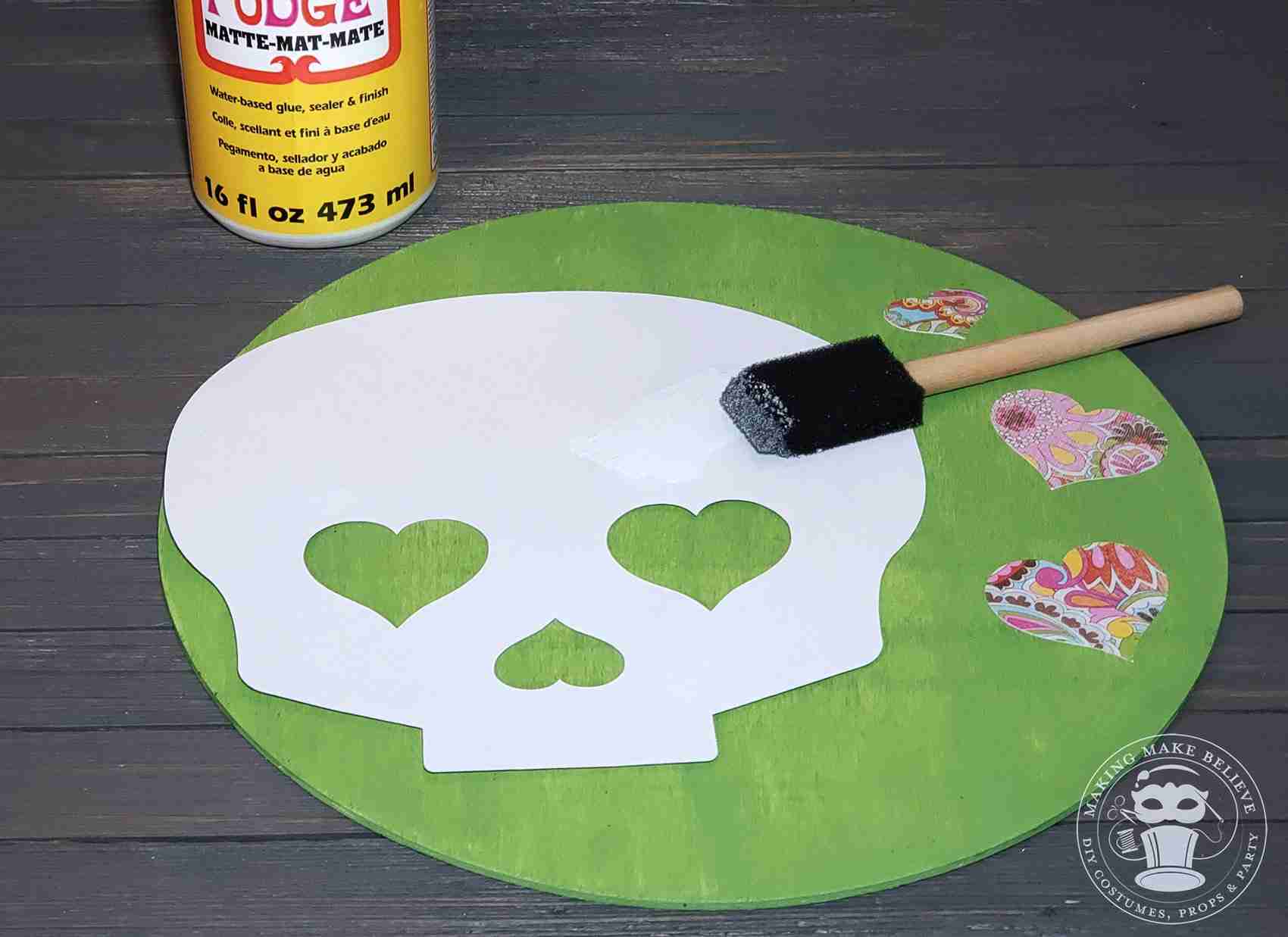 Apply Mod Podge to back of paper skull