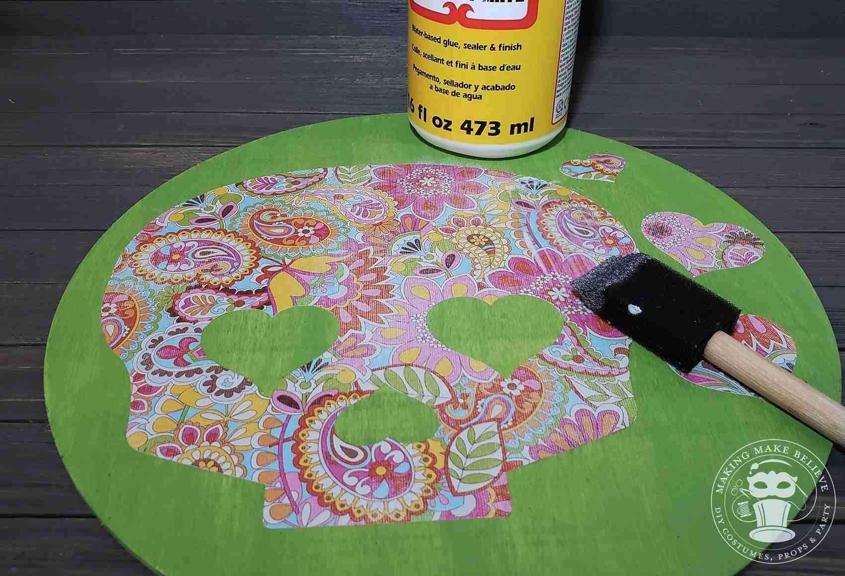 Place paper skull on disc and apply thin coat of Mod Podge