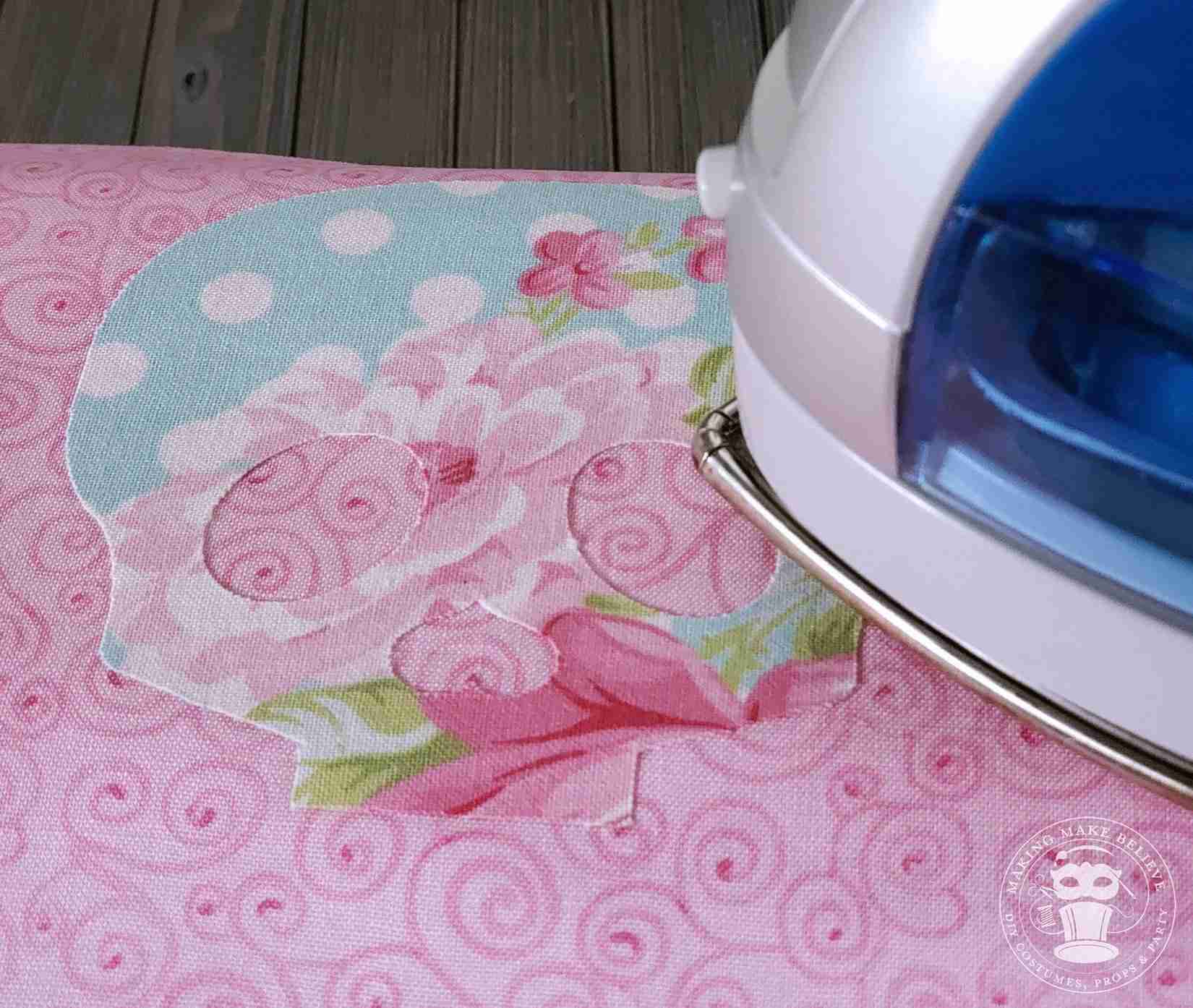 Place skull on backing fabric and iron